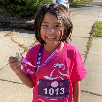 Girls on the Run participant smiling while running